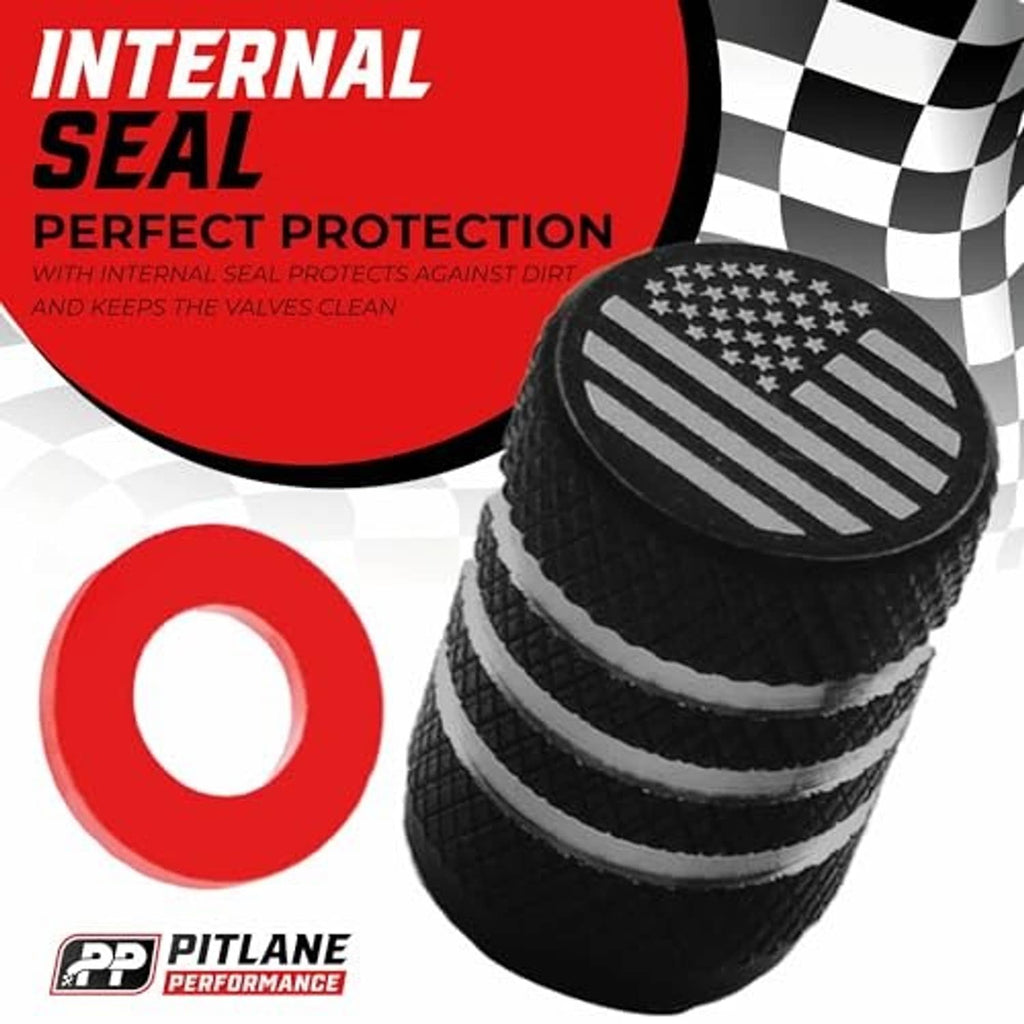 Black aluminum valve stem cap with engraved U.S. flag top, shown among stacked caps.
