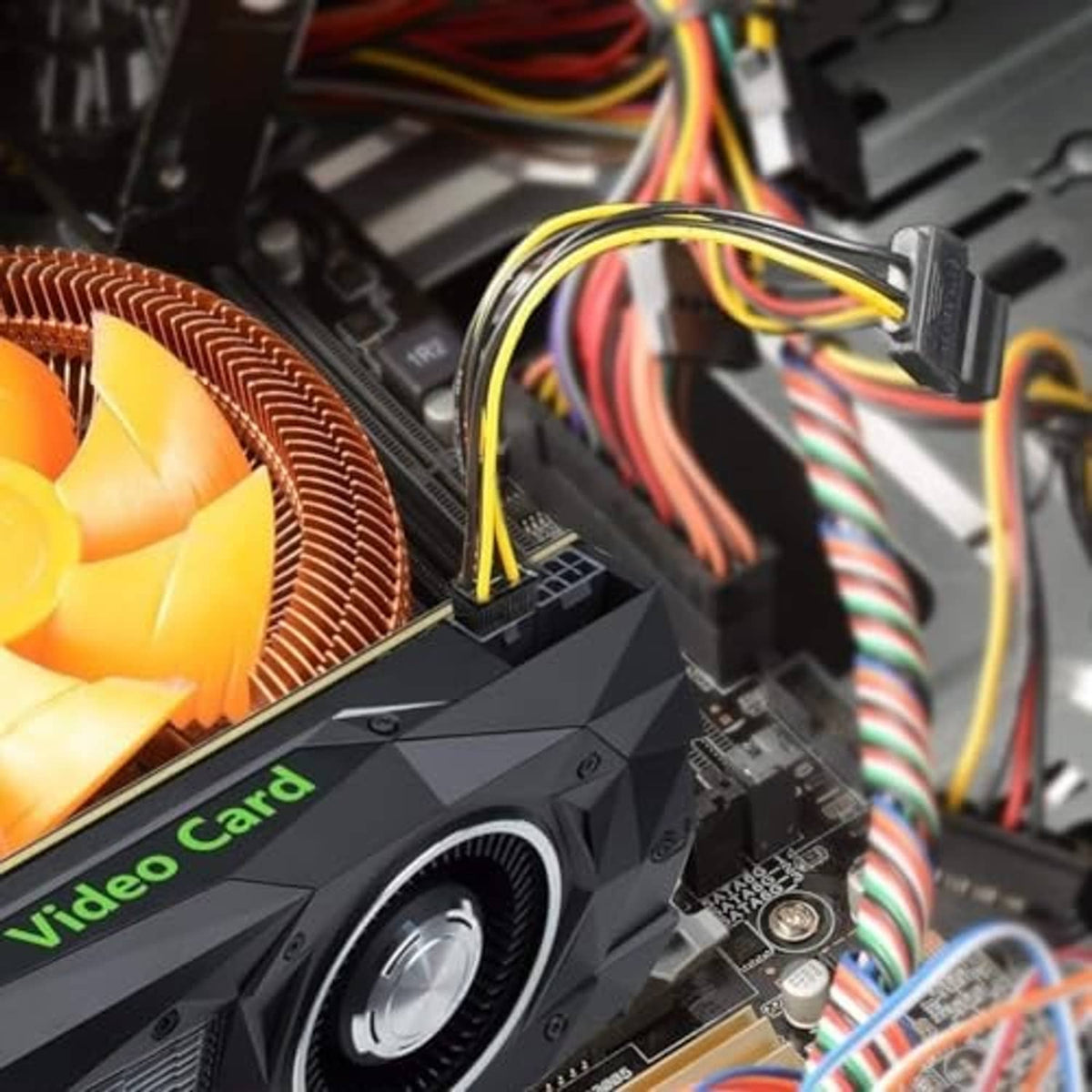 6-pin PCIe power connector near graphics card, black housing with yellow-and-black wiring.