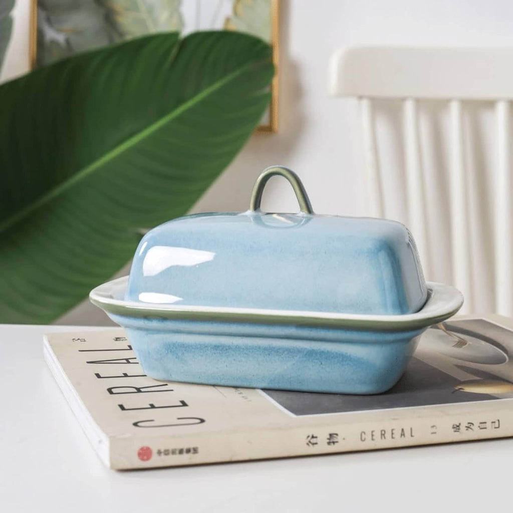 Blue ceramic butter dish with lid, low rectangular serving dish with curved rim