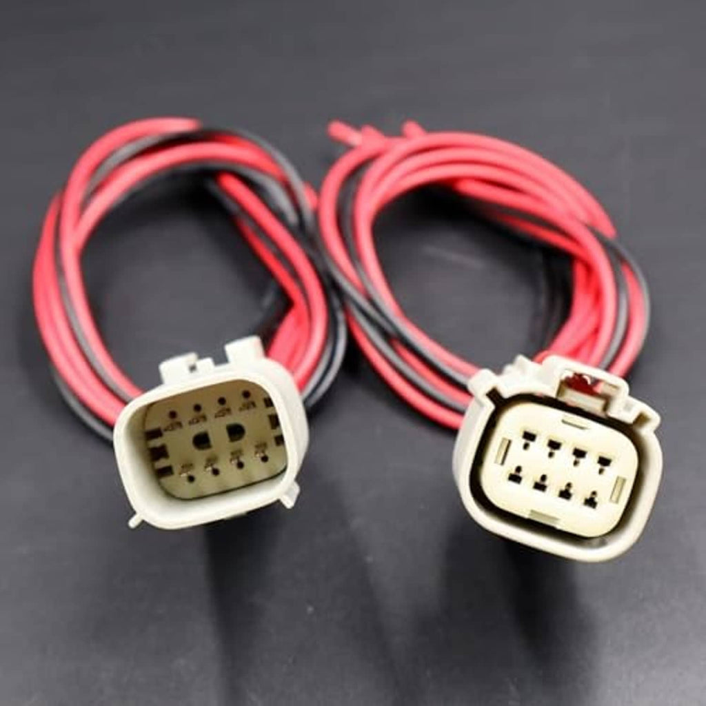 Two LED headlight connector plugs with red/black wires and white housings