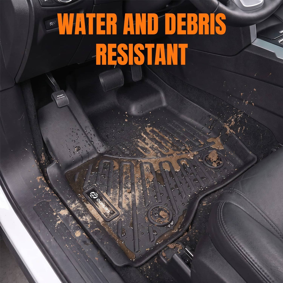 Black rubber floor mat liner in vehicle footwell with textured ridges and raised containment edges