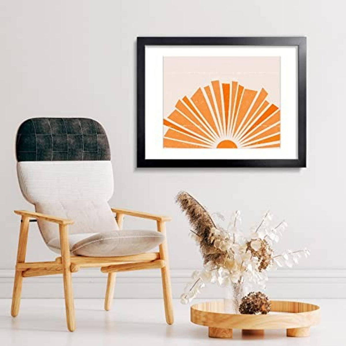 Black picture frame with white mat, holding orange sunburst print