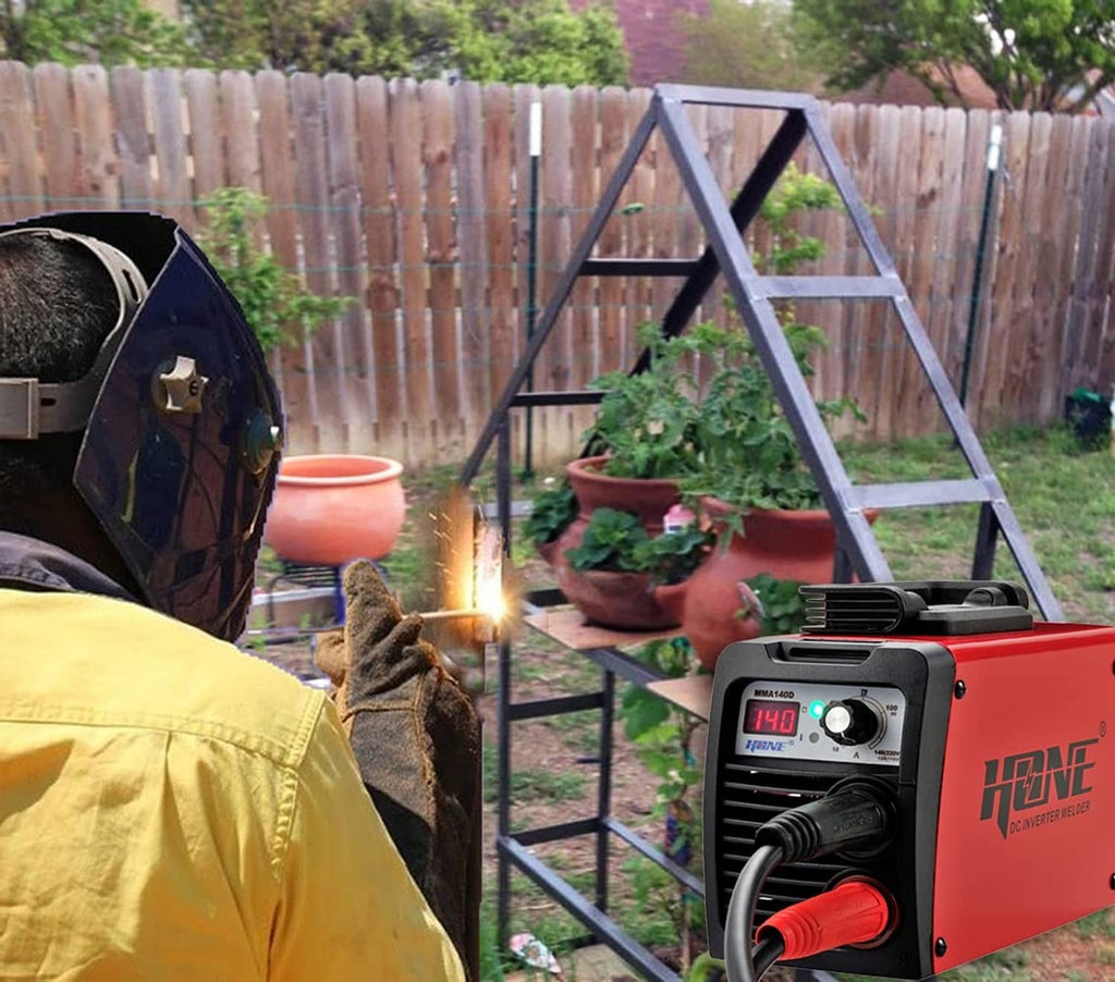 Stick welder in use with welding sparks near metal frame and outdoor plants