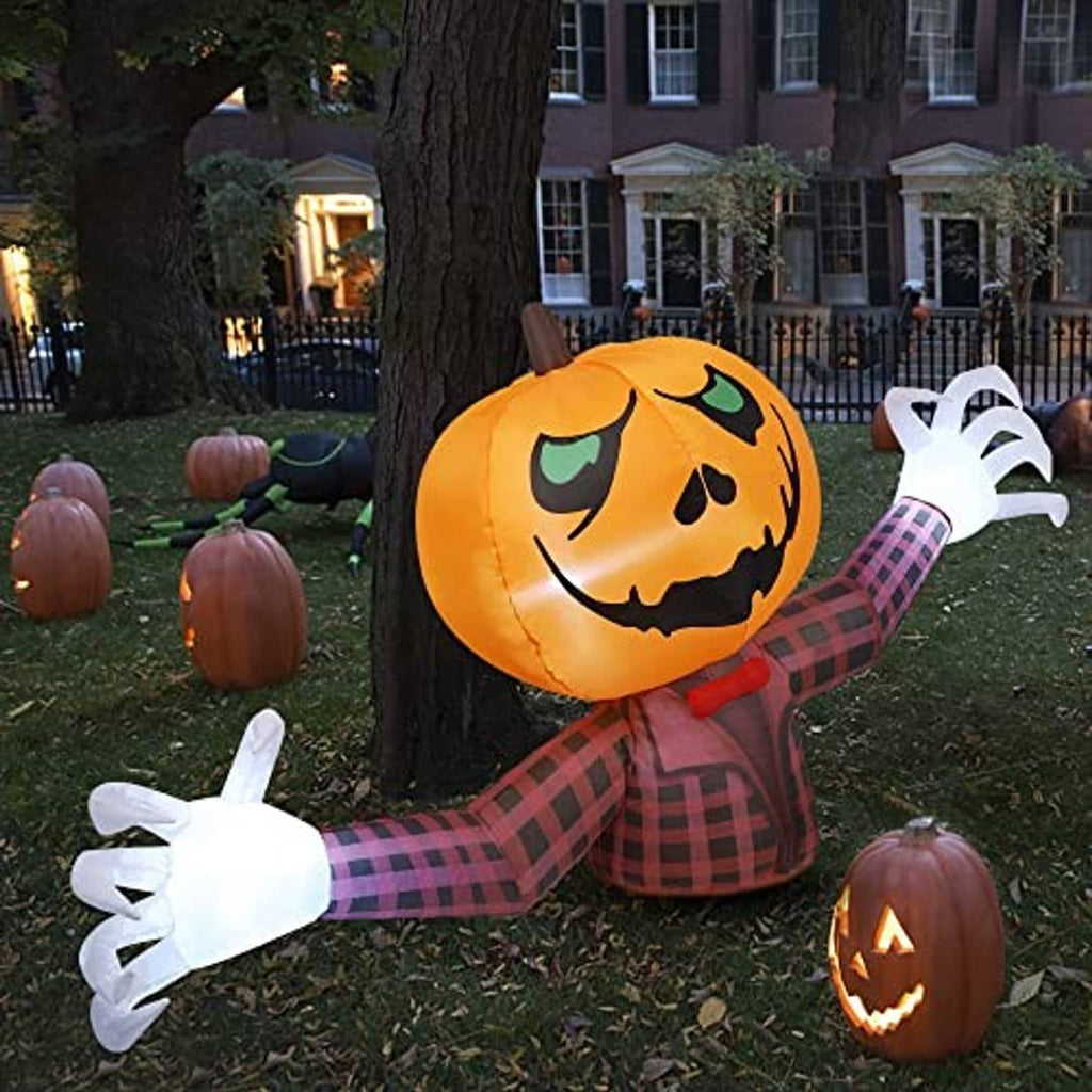 Inflatable pumpkin ghost with orange jack-o-lantern face, red plaid arms, white pose hands