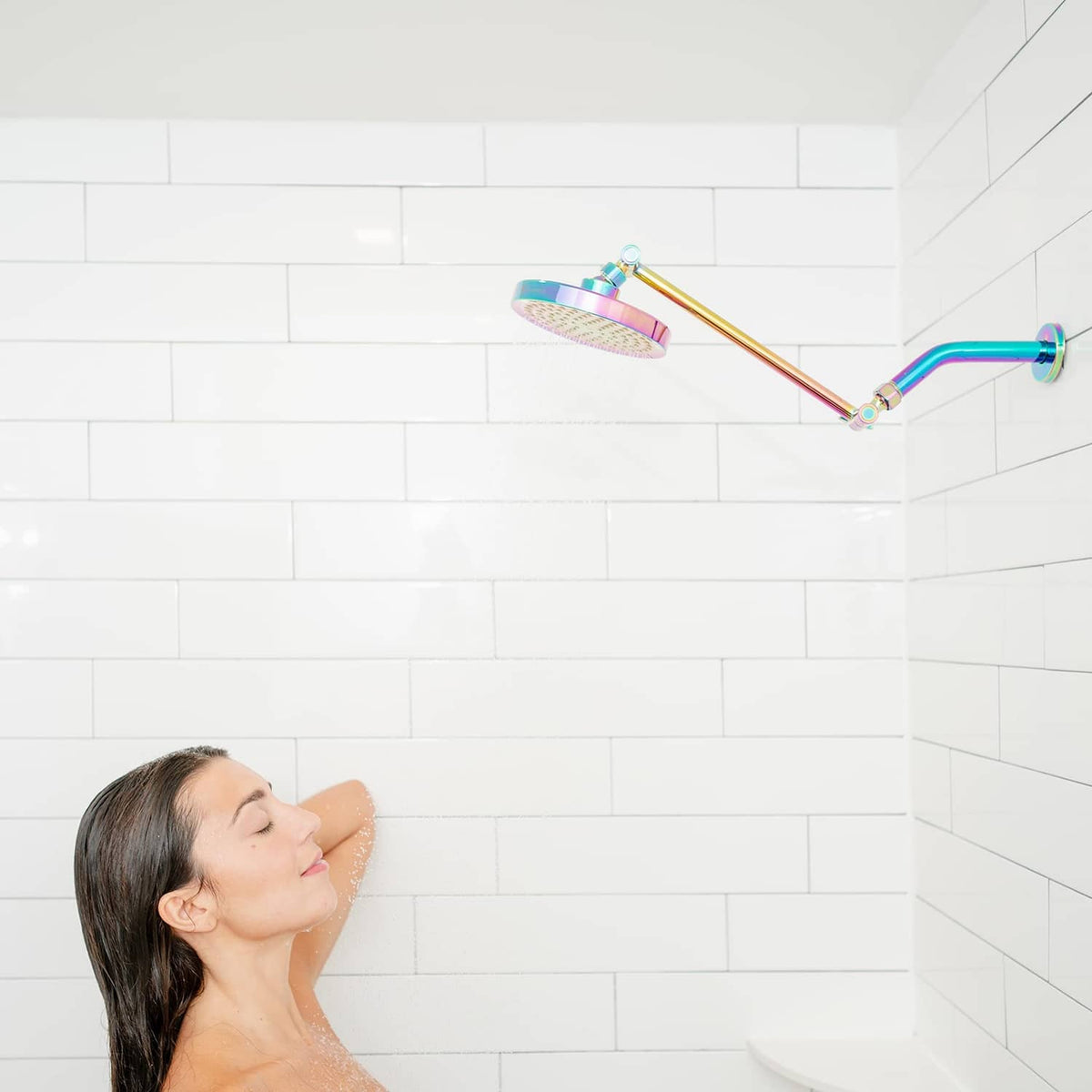 Rainbow rain shower head spraying water over a seated person in the shower