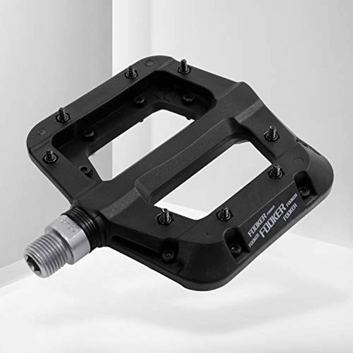 Black mountain bike flat pedals with open platform, grip studs, and threaded axle