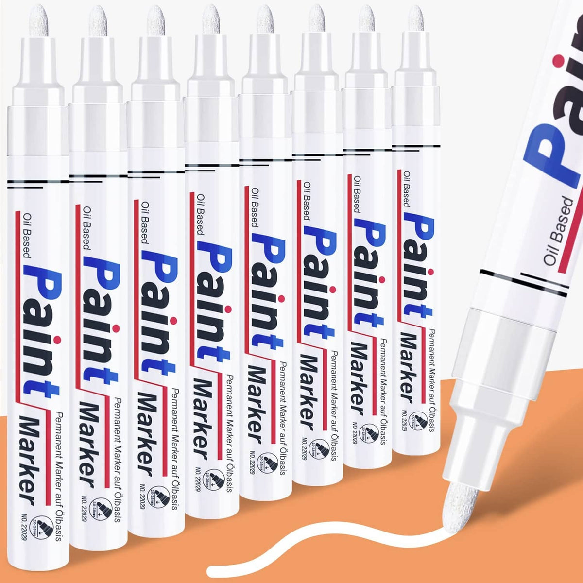 Set of white permanent paint markers with screw-top caps, multiple markers in a row