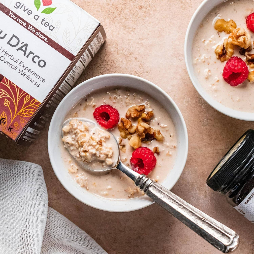 Herbal tea box with brewed tea in a bowl topped with raspberries and walnuts