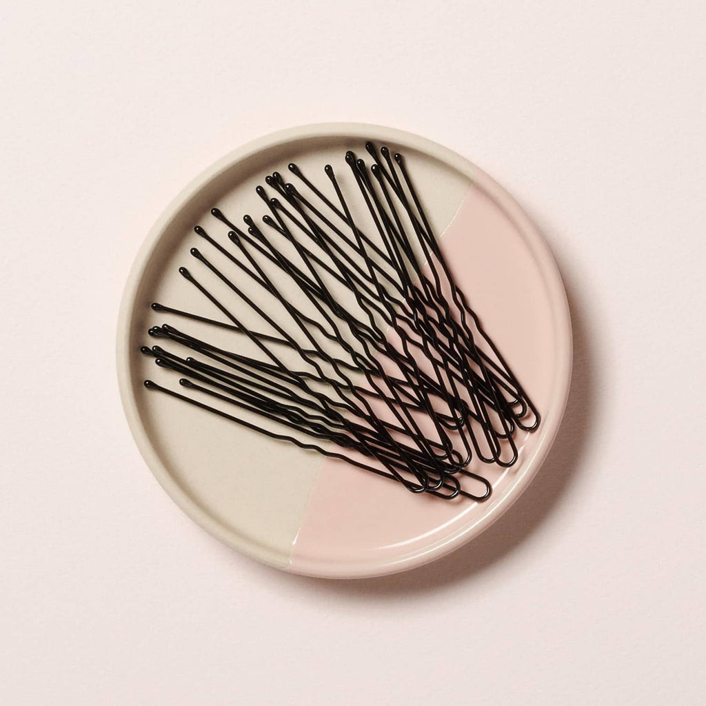 Coiled black hair pins in a round dish, 3-inch extra large U-shaped design