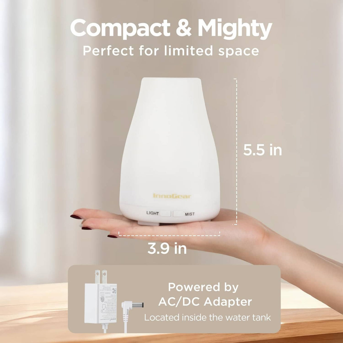 White essential oil diffuser with compact size design, held in a hand