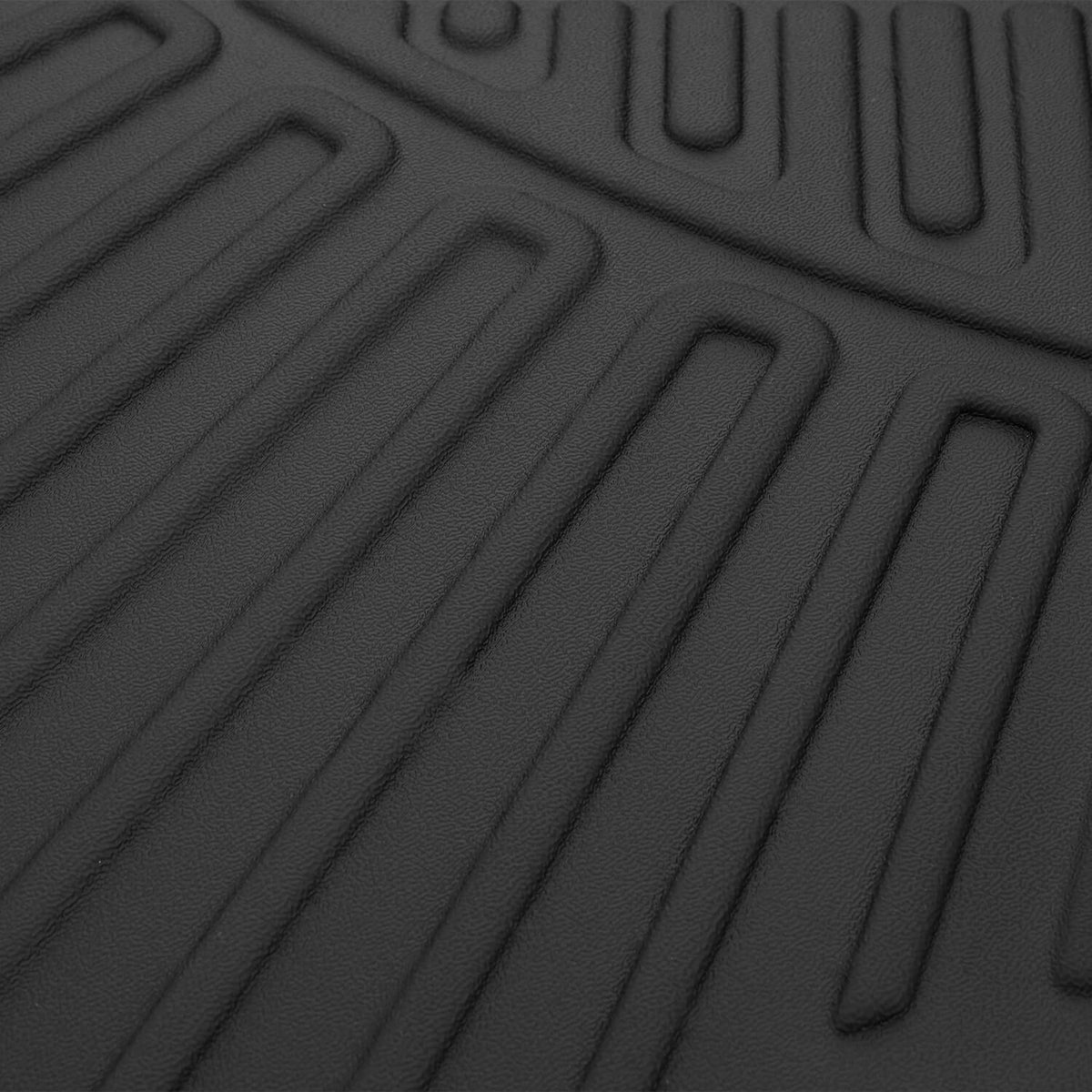 Black molded mat with close-up parallel traction ridges and molded texture details