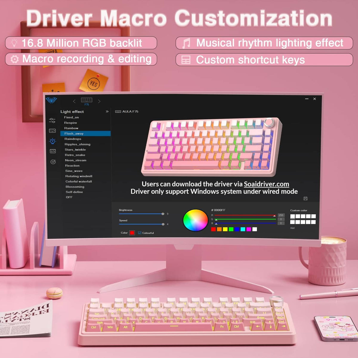 Pink mechanical keyboard with RGB backlit keycaps, placed in front of a monitor