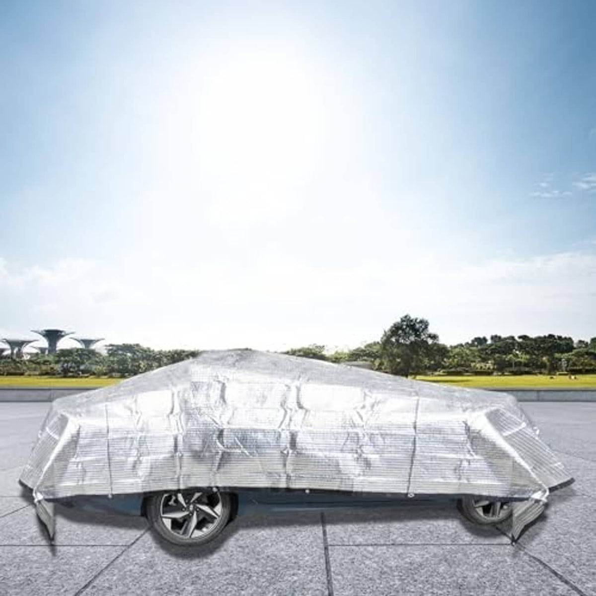 Light gray mesh cover tarp draped over a car for sun protection