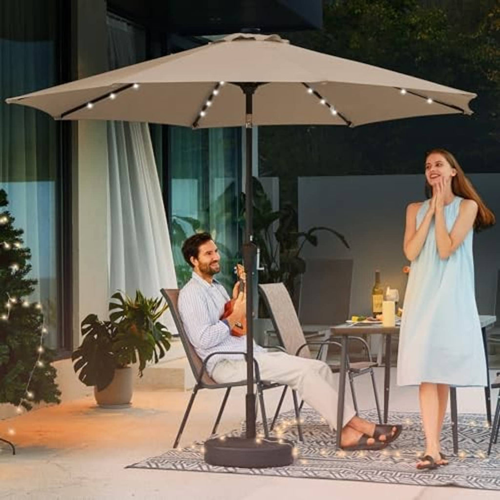 Beige outdoor patio umbrella with LED lights open over seating area
