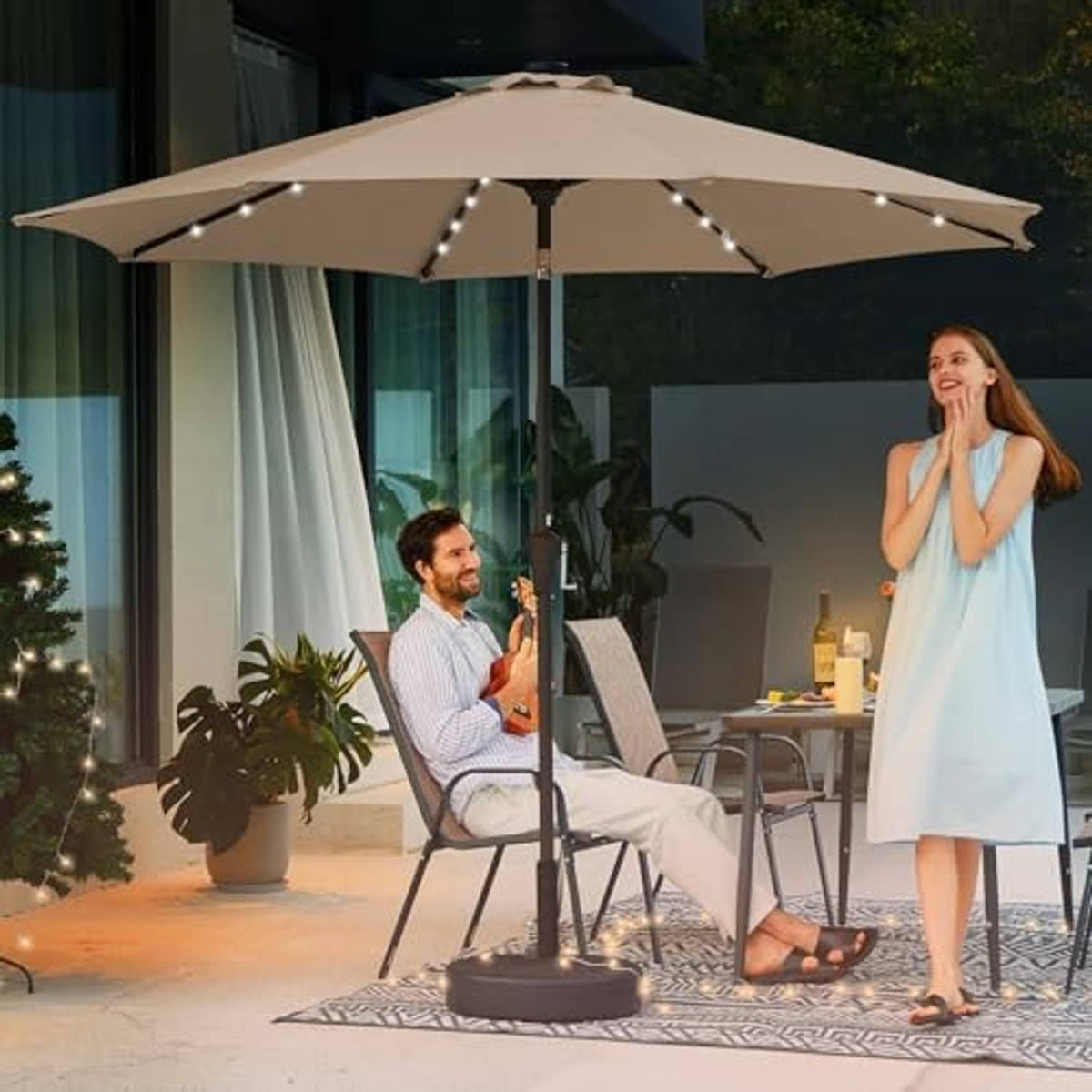 Beige outdoor patio umbrella with LED lights open over seating area