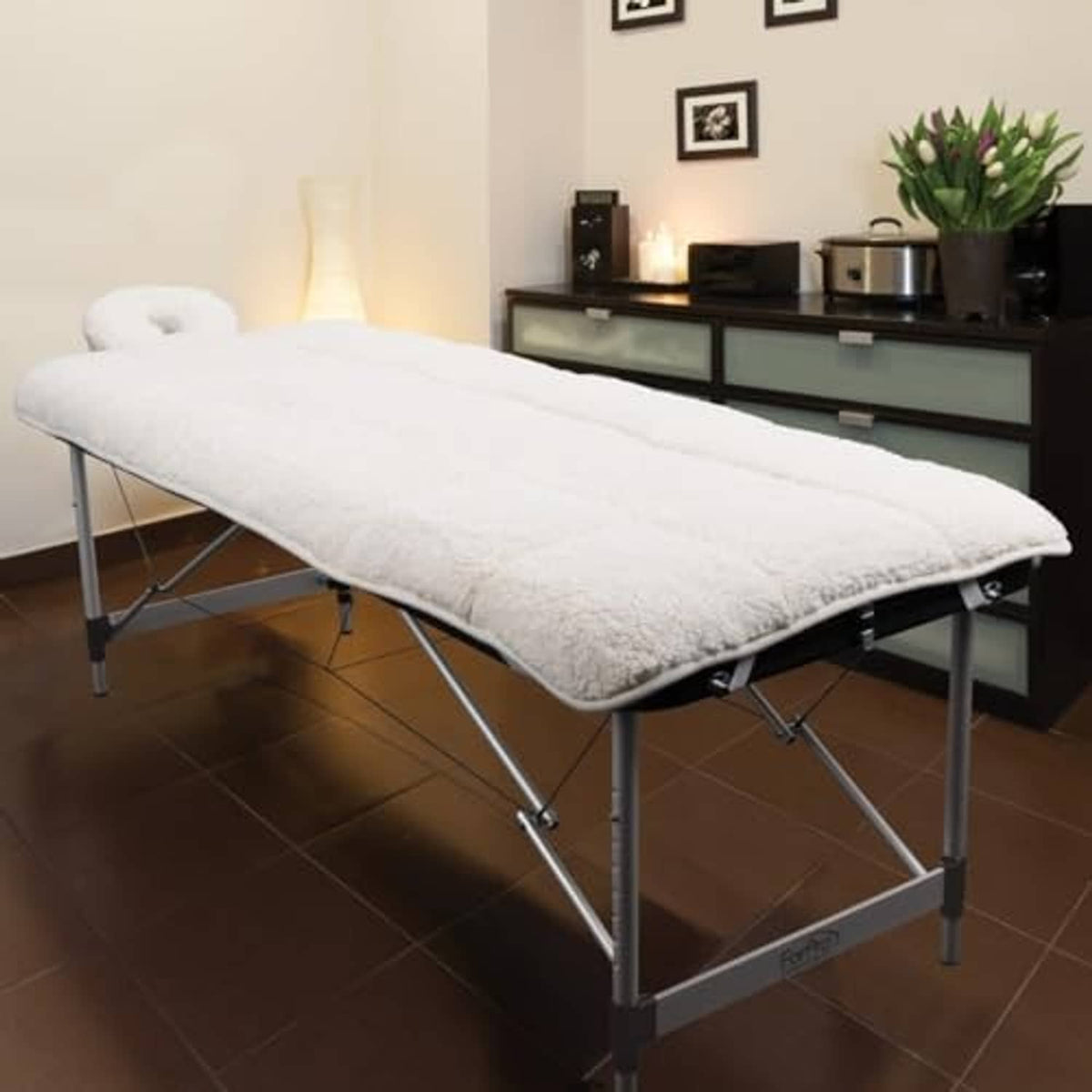 Natural quilted fleece massage table pad on folding table, extra-soft plush cover.