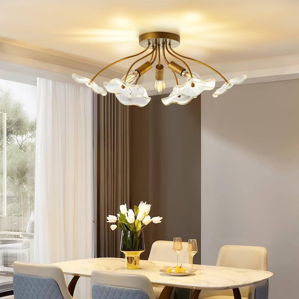 Brass semi flush ceiling light with clear glass shades over a dining table