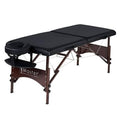 Black portable massage table with armrest and walnut legs