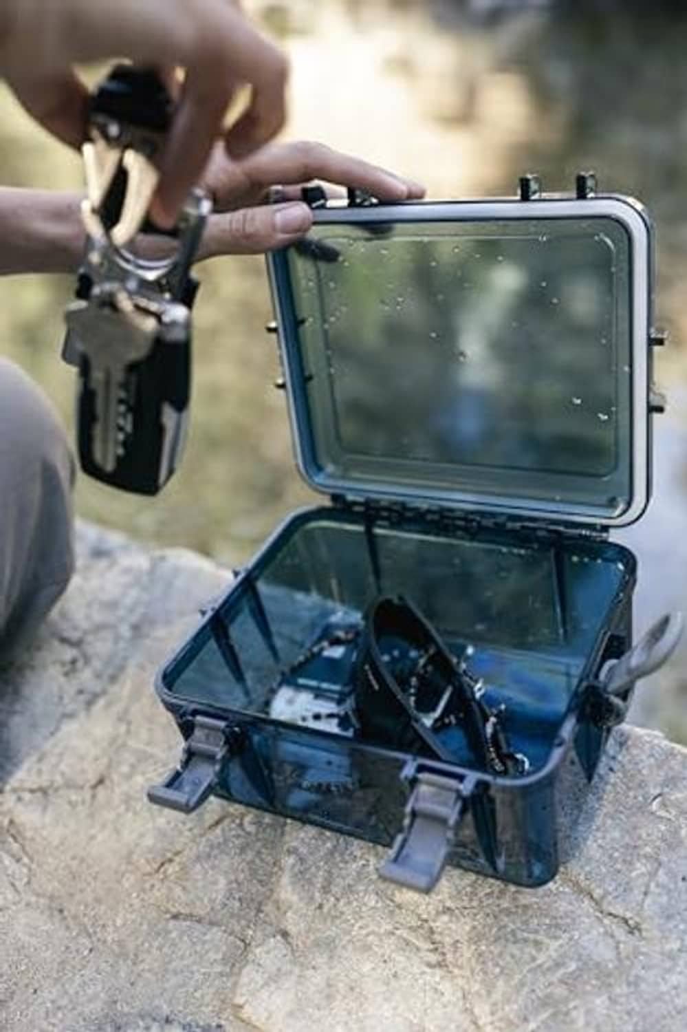 Open blue watertight box with clear lid, hinged interior compartment