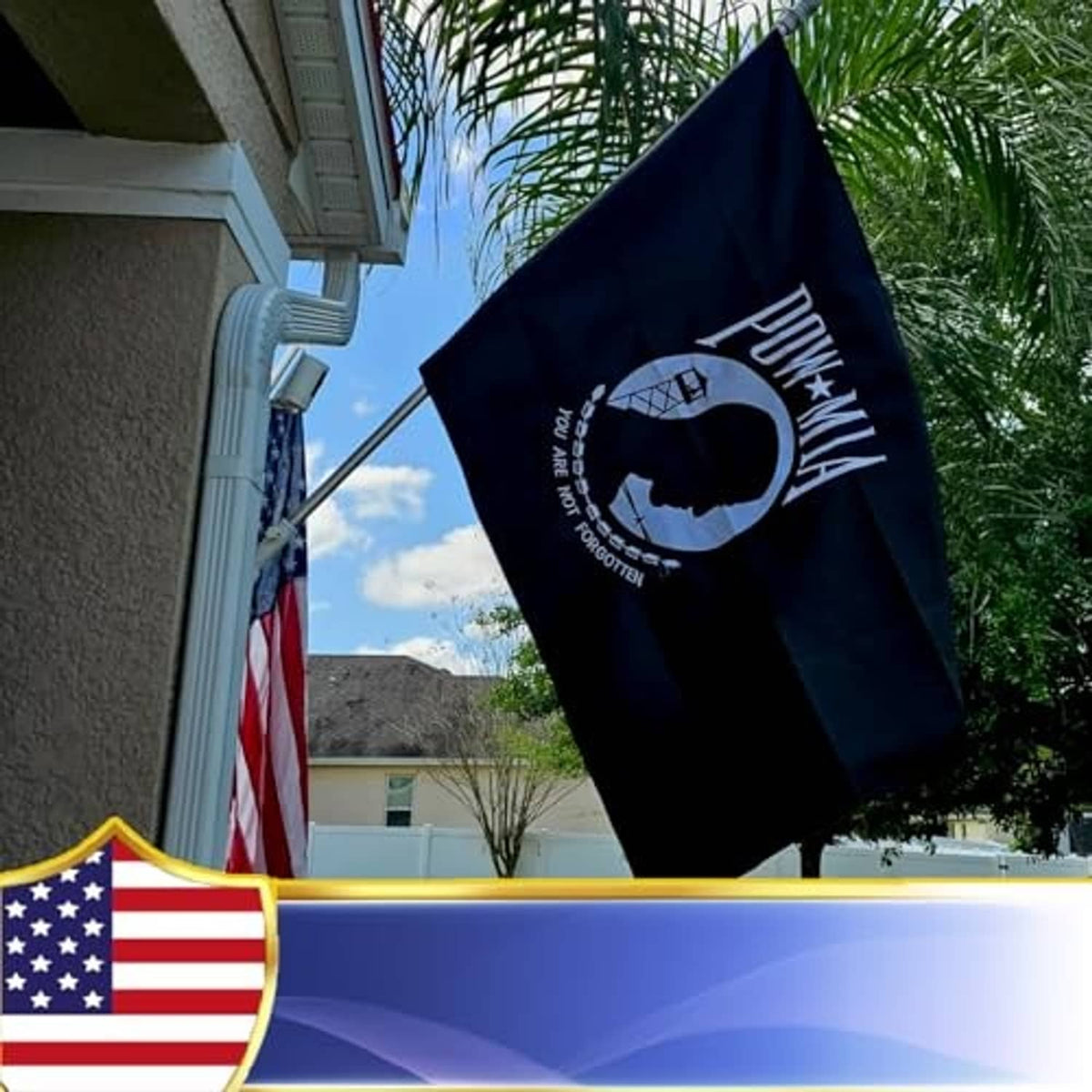 Black POW-MIA embroidered outdoor flag flying outdoors with central circular emblem