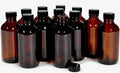 Amber glass bottles with black caps, multiple bottles
