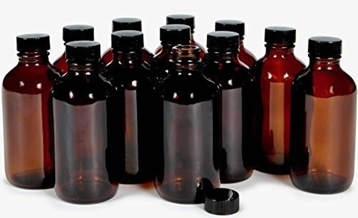 Amber glass bottles with black caps, multiple bottles