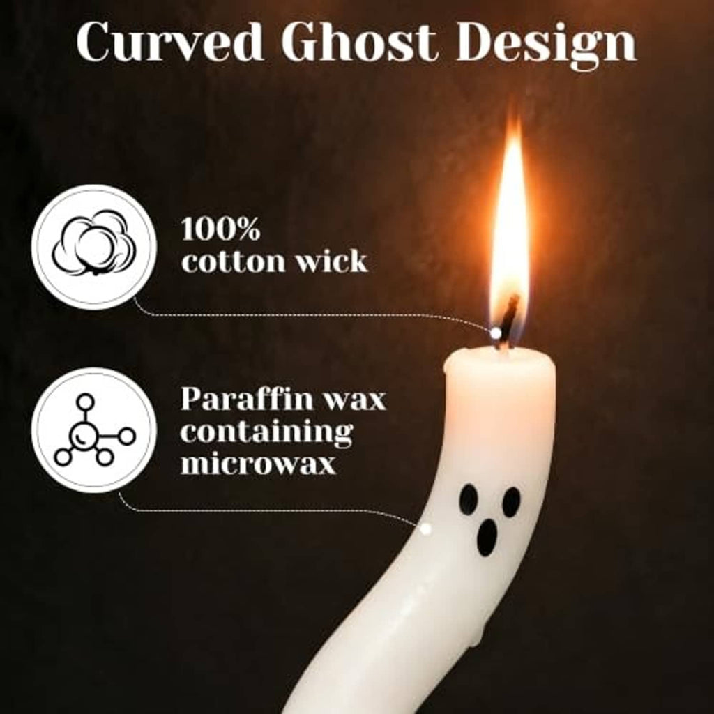 Close-up of a white curved ghost candle with black eye dots and lit flame