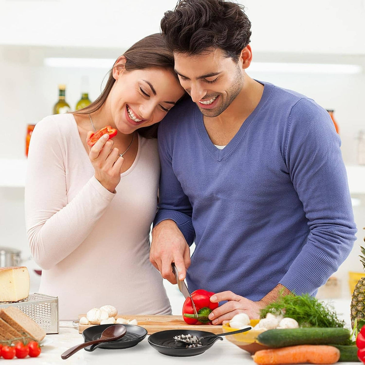 Black spoon rest on countertop with wooden spoon holding utensils during cooking