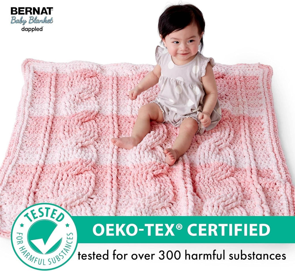 Pink dappled chunky knit baby blanket with raised textured blocks