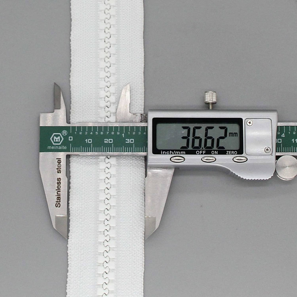 White separating zipper measured with a digital caliper, showing length in mm