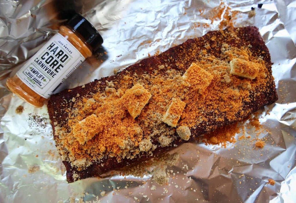 Seasoned meat roast with Hardcore Carnivore spice rub and bottle