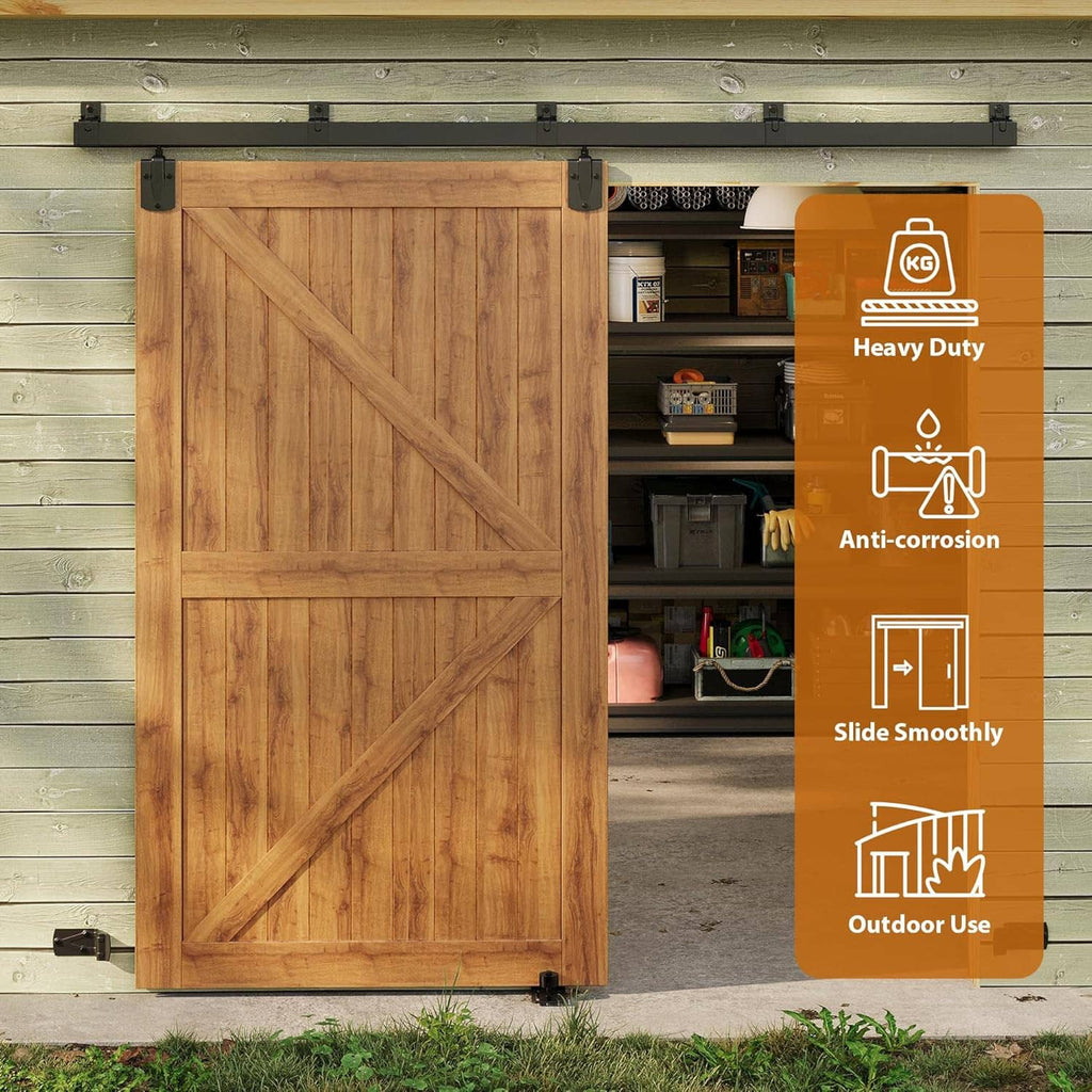 Heavy-duty barn door hardware kit with black track and rollers beside wooden door