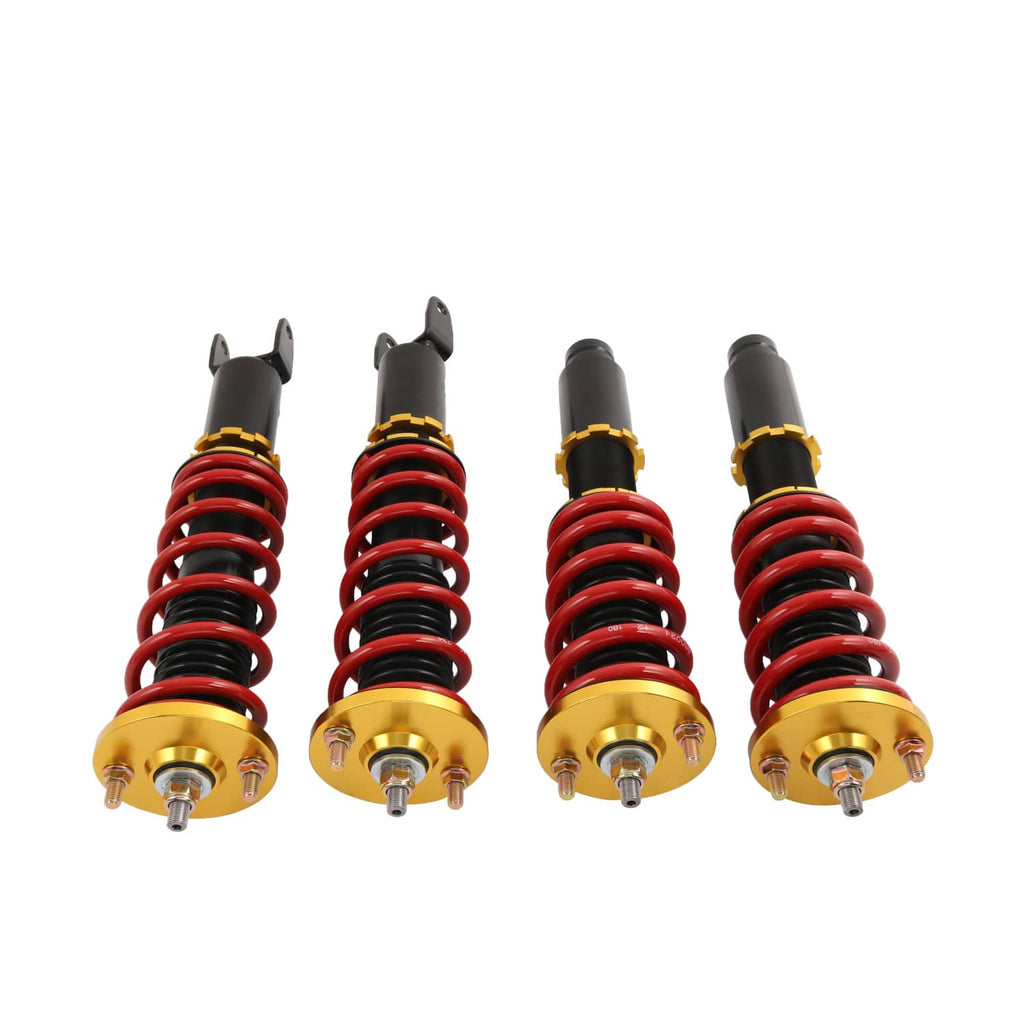 Four adjustable coilover struts with red springs, black dampers, and gold adjustment tops.