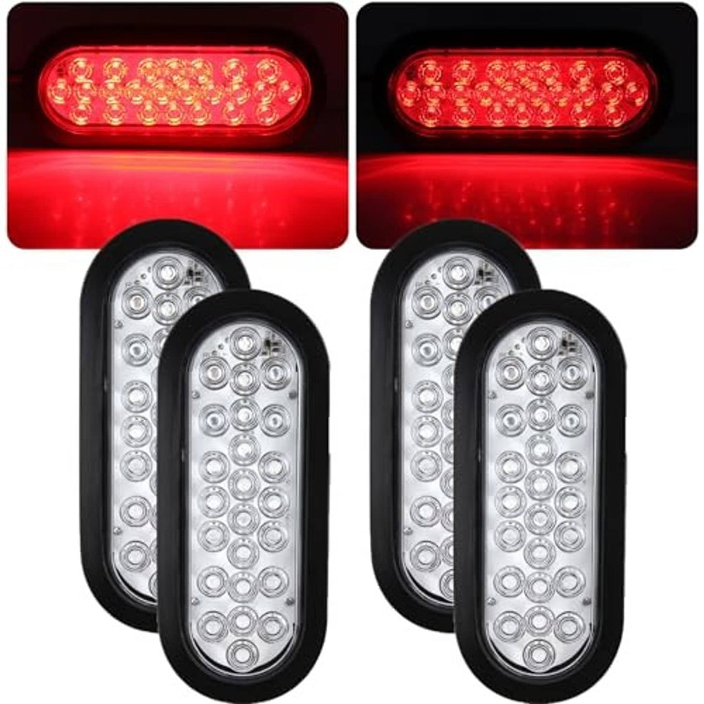 Set of oval LED trailer tail lights with clear lenses and red glow, black housings
