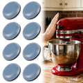Grey round appliance slider pads set next to a stand mixer on a countertop
