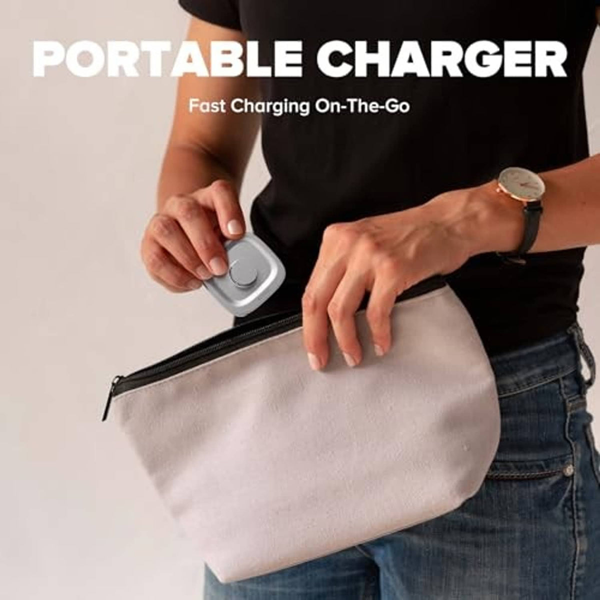 Portable silver ring charger puck with cable, held in a hand