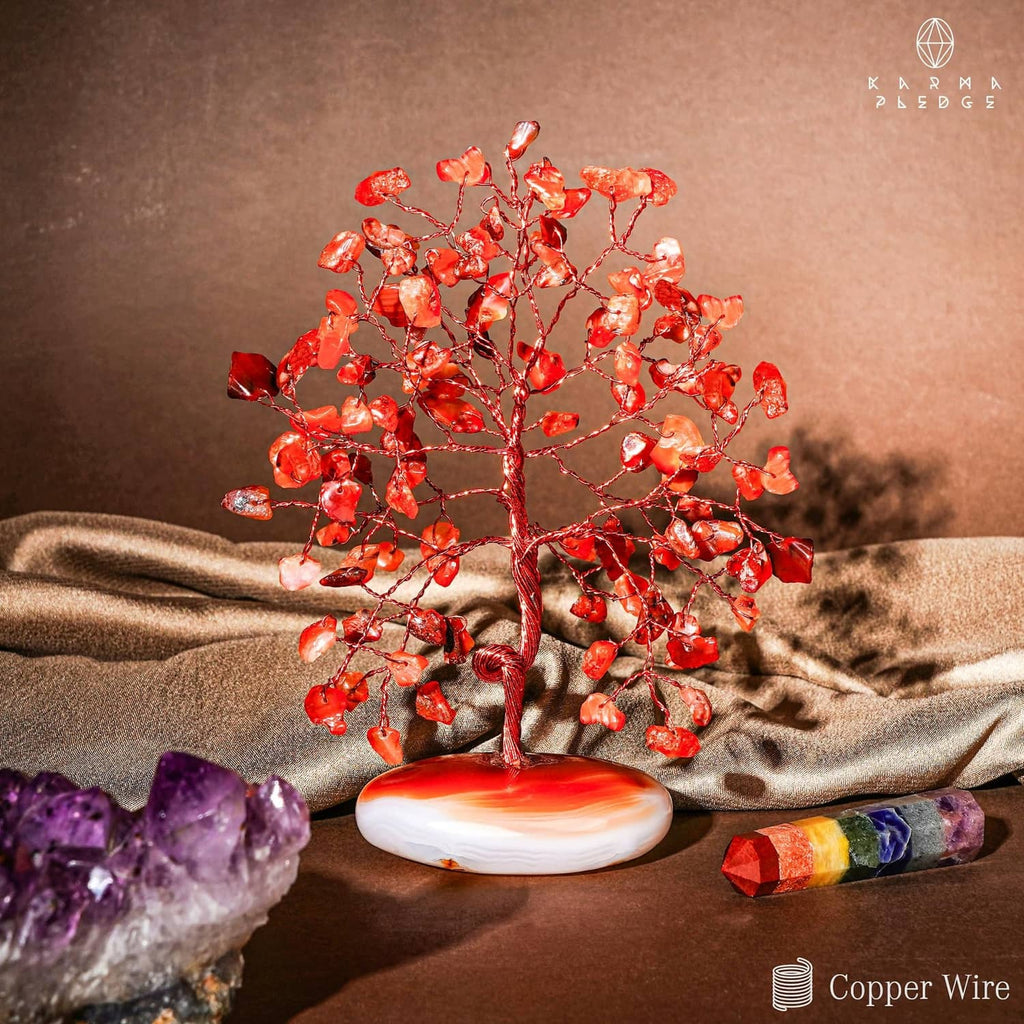 Orange-red carnelian tree figurine with clustered crystal leaves on white base
