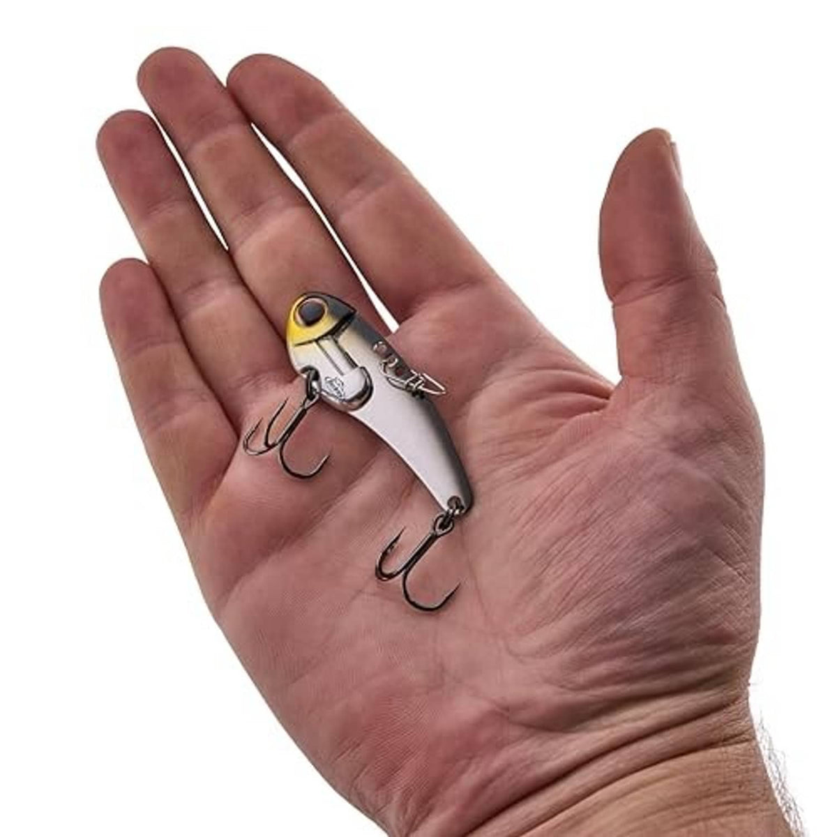 Two small yellow and silver fishing lures with red eyes, resting on open palm