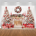 Christmas fireplace backdrop with wreath, wrapped gifts, and trees in red and white decor