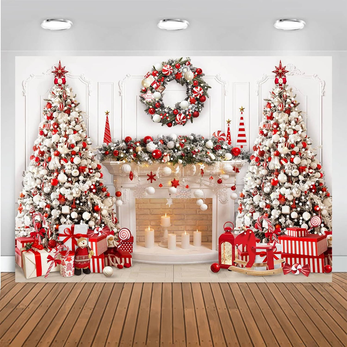 Christmas fireplace backdrop with wreath, wrapped gifts, and trees in red and white decor