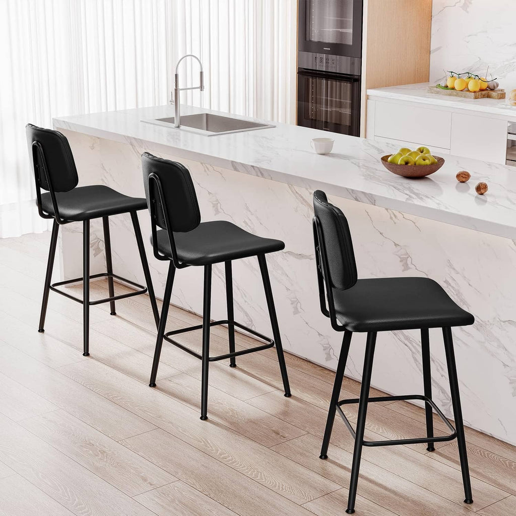 Four black counter-height bar stools with padded seats and backs, metal frames, footrests.