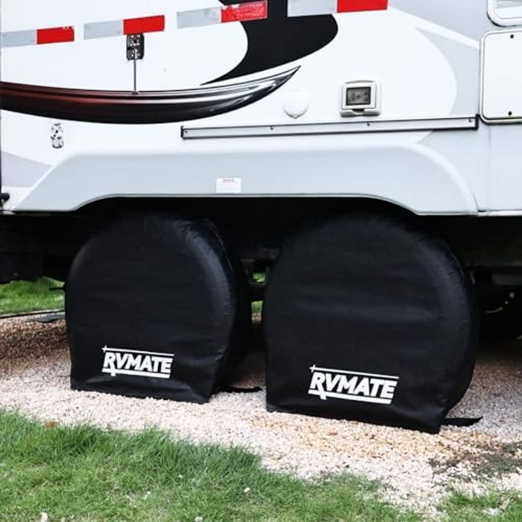 Two black RV tire covers with RVMATE logo, rounded covers fitted on trailer tires