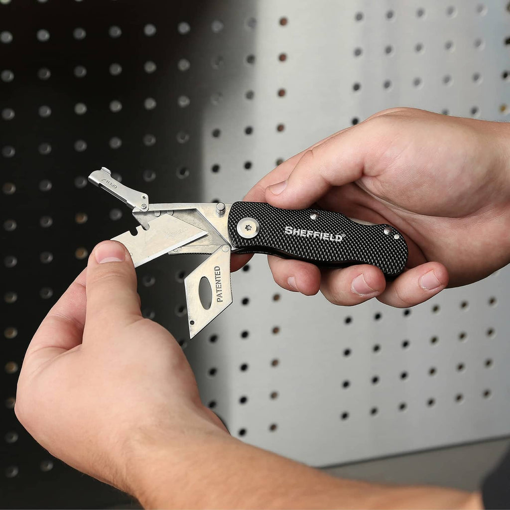Folding utility knife with blade lock; compact folded profile; black textured handle