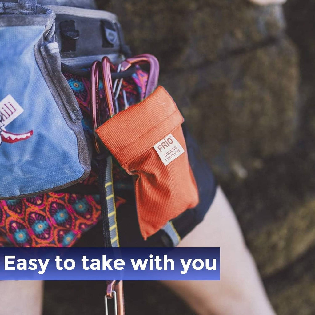 Orange FRIO cooling wallet tucked into a bag pocket while traveling