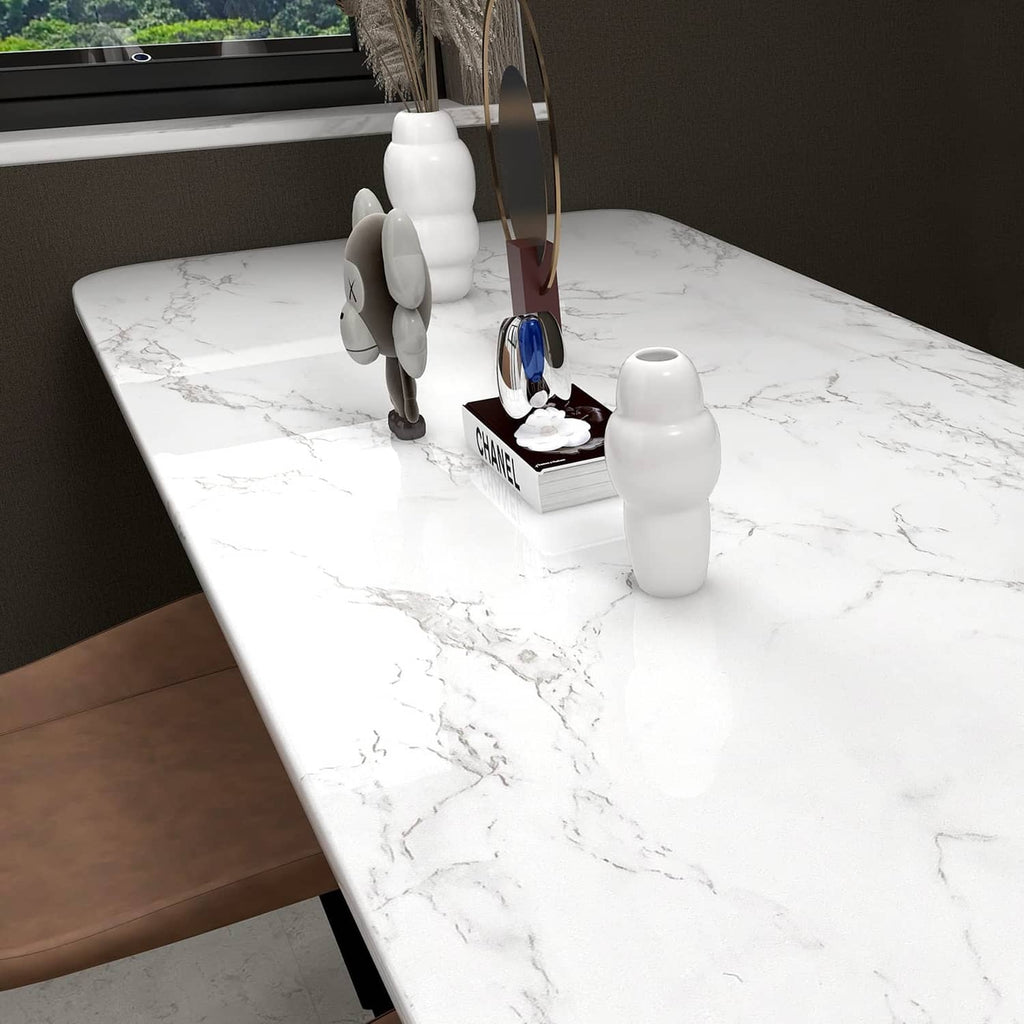 Glossy white marble contact paper applied to a large rectangular tabletop with gray veins