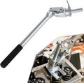 Valve spring compressor tool with long silver shaft and black rubber grip handle