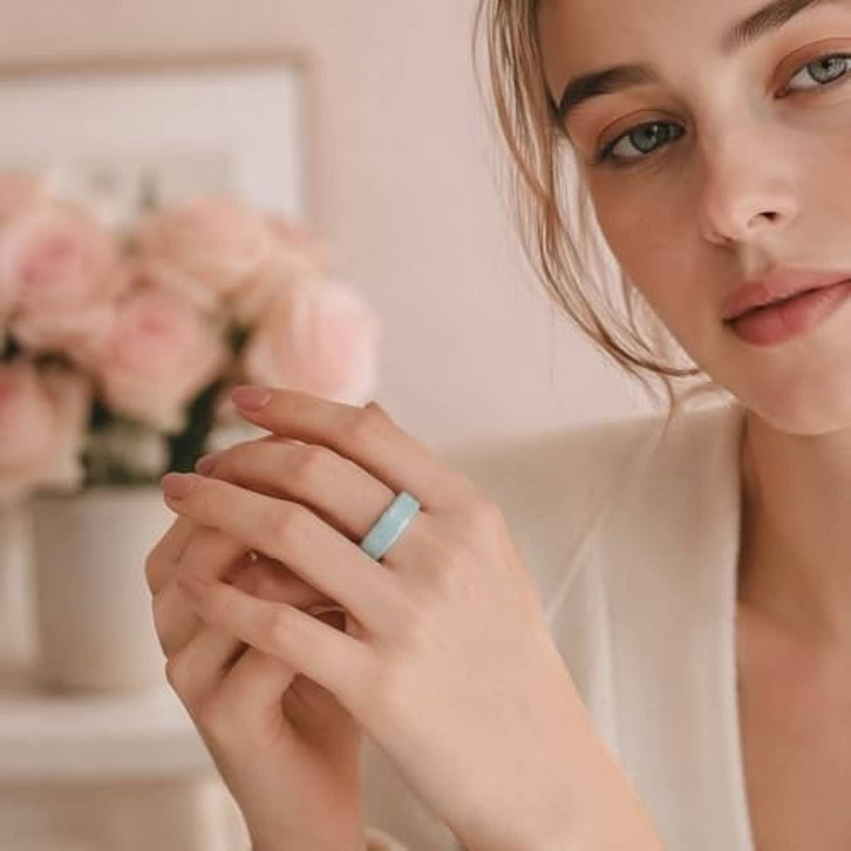Mint ring cover on a hand, matte band with small icon detail on the side