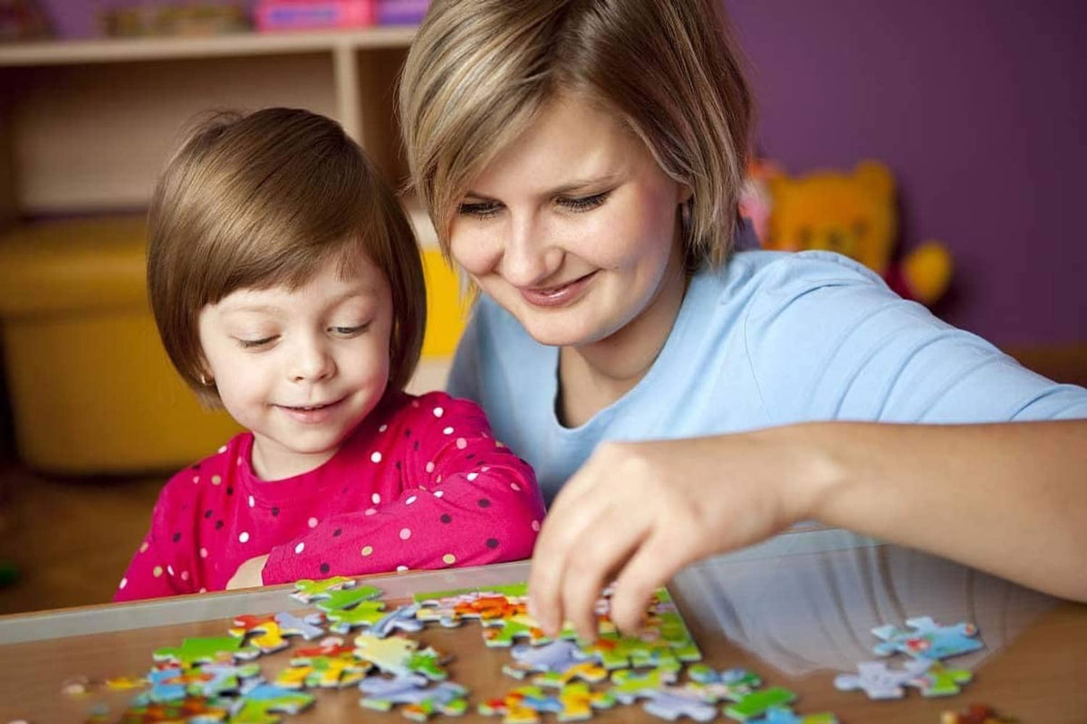 Adult and child assembling a colorful animal jigsaw puzzle on a tabletop