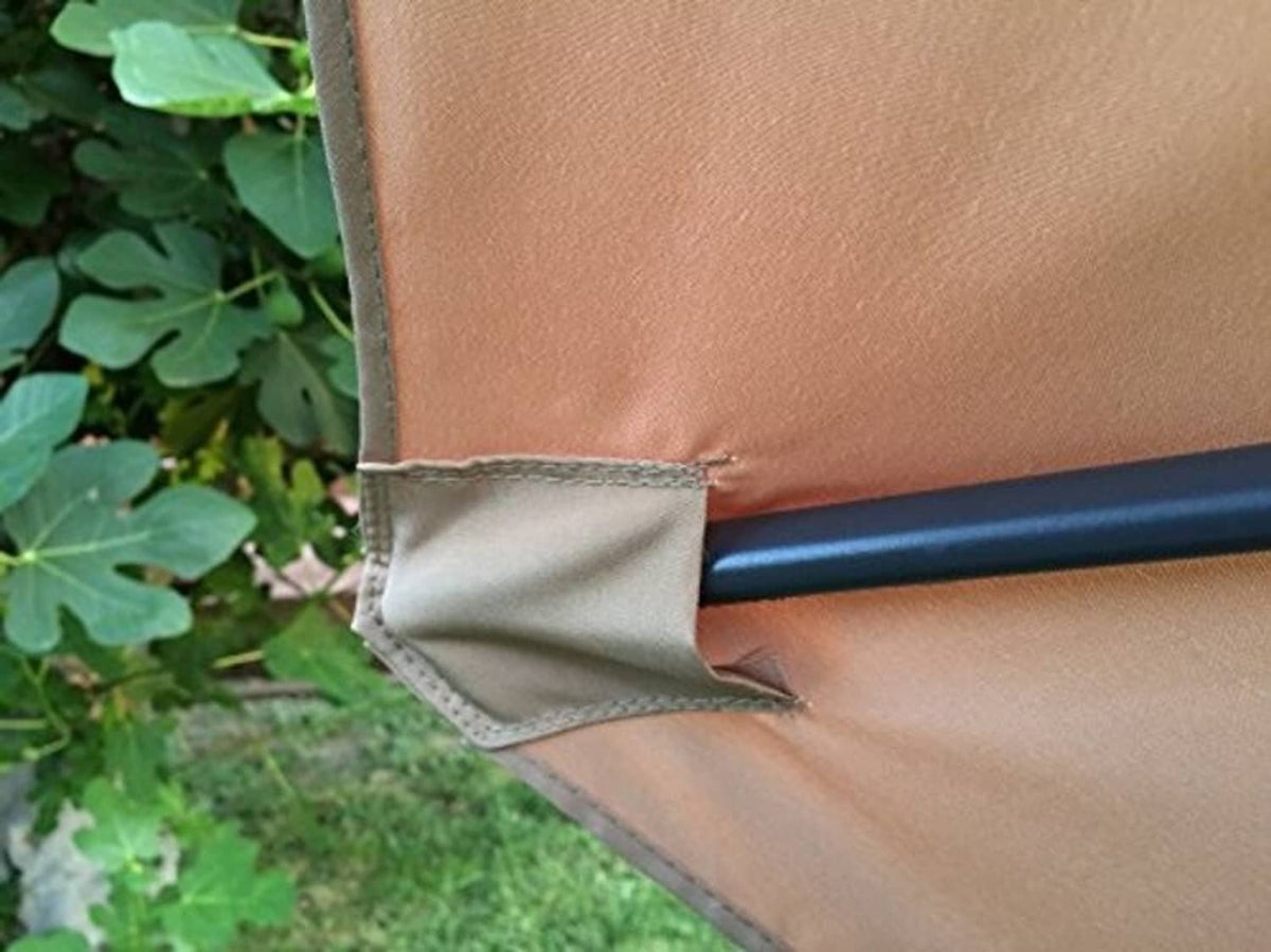 Tan umbrella canopy fabric with grey pole sleeve and stitched edge seam detail.