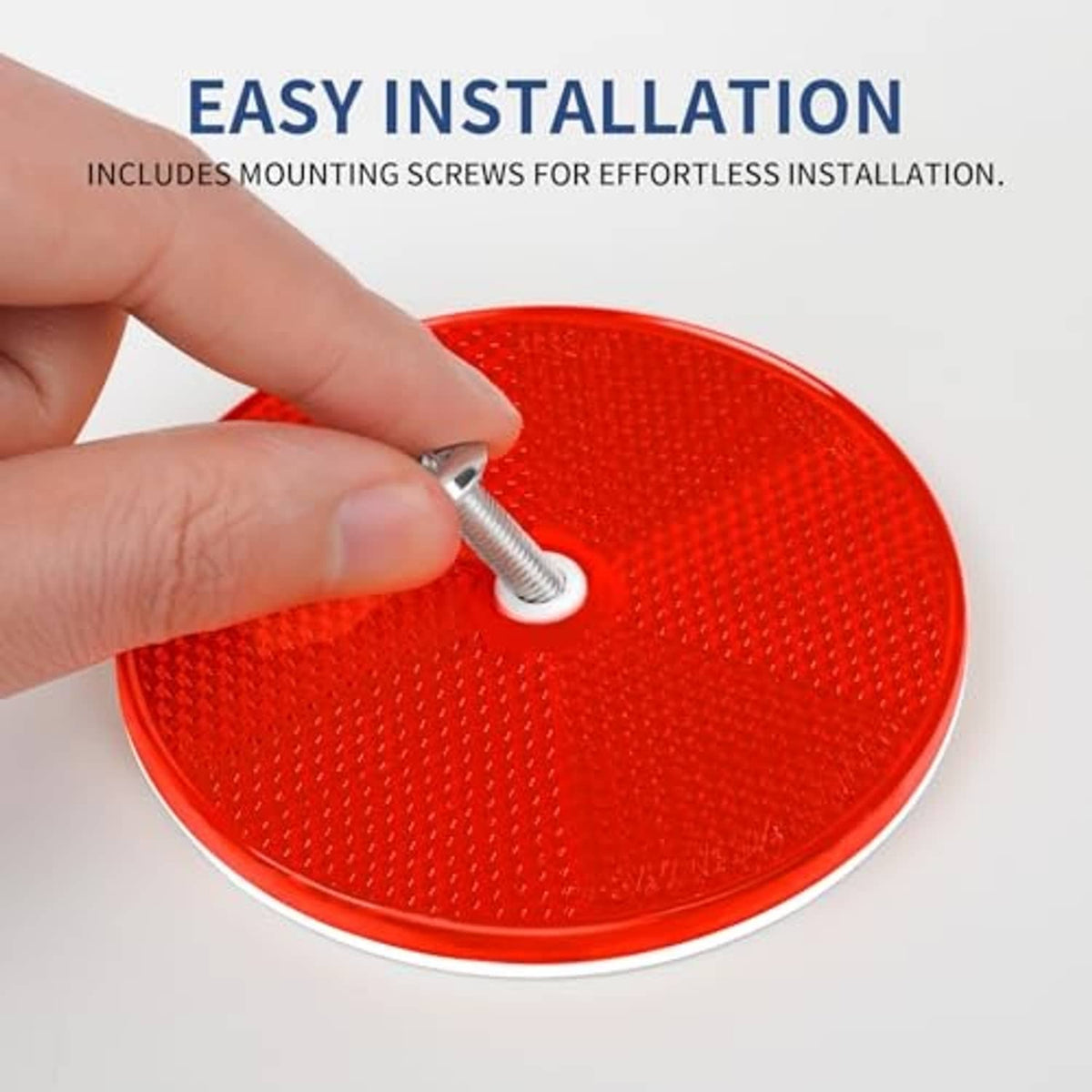 Red round screw-on reflector being installed with a metal mounting screw